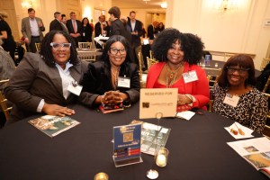 Three women in formal dress at table
