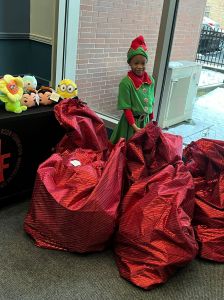 Child with gift bags in elf costume